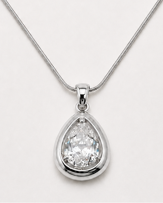 A silver-tone necklace featuring a teardrop-shaped pendant with a clear faceted gemstone, displayed on a clean white background.